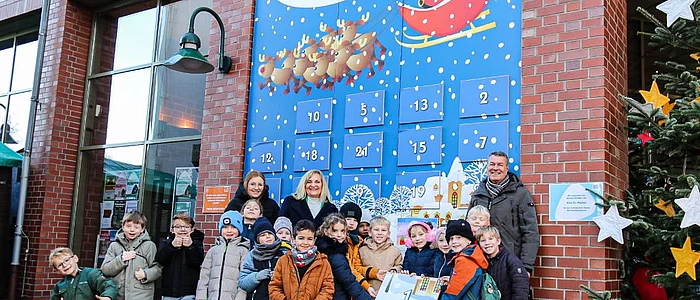 Gruppe mit Kindern vor Adventskalender der Stadt Georgsmarienhütte